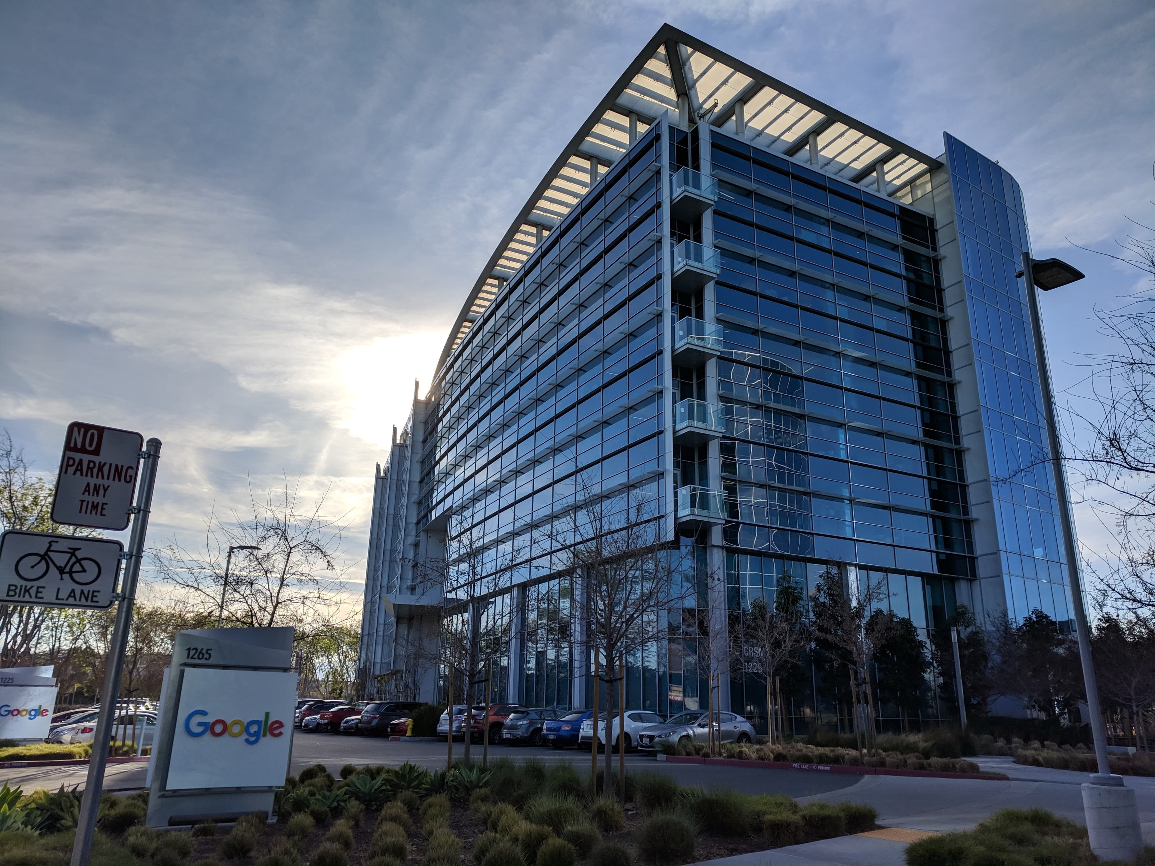 A Google office building with a glass facade and Google signage at 1265 Crossman Avenue in Sunnyvale, California.
