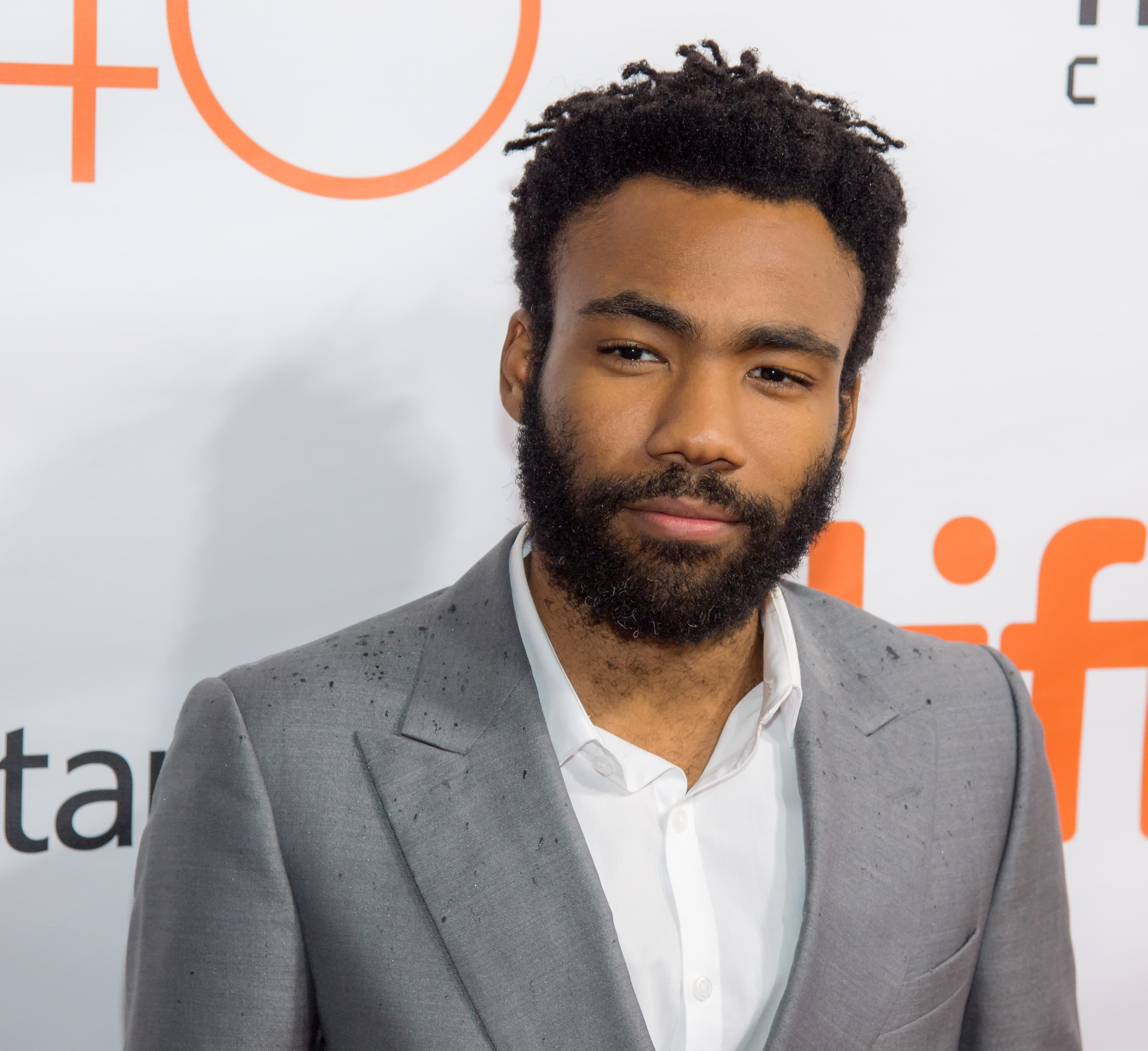 Donald Glover in a gray suit at The Martian premiere during the 2015 Toronto International Film Festival.