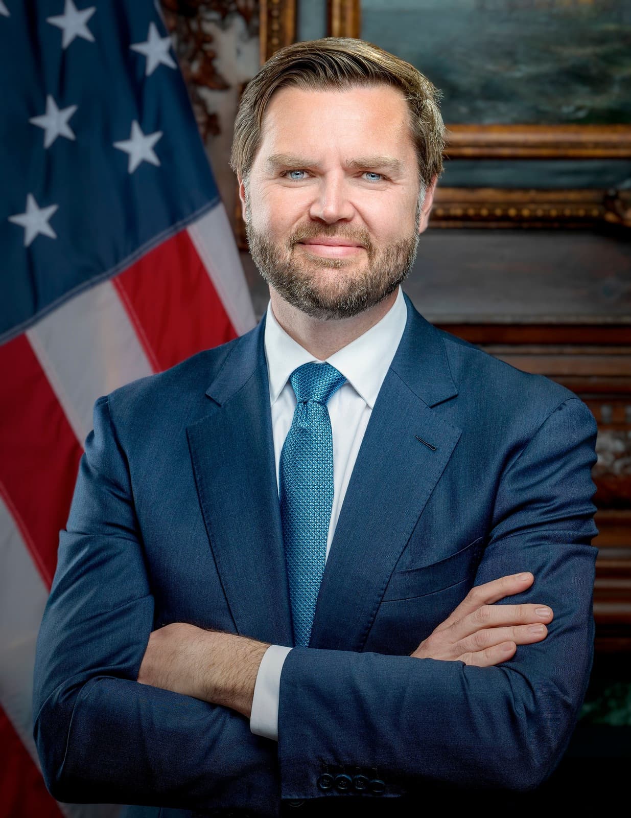 Official January 2025 portrait of Vice President JD Vance in a blue suit before a United States flag.