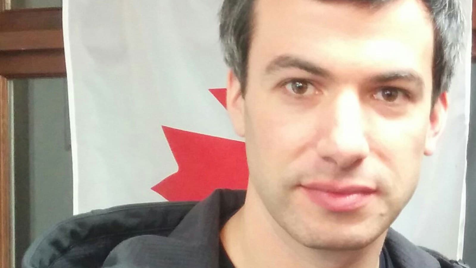 Nathan Fielder, co-director of the documentary 'You Can See Everything,' in front of a Canadian flag in Vancouver in a 2017 archive photo.