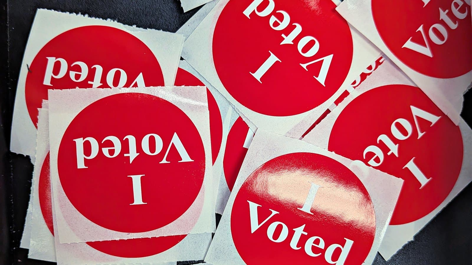 A pile of red and white "I Voted" stickers.