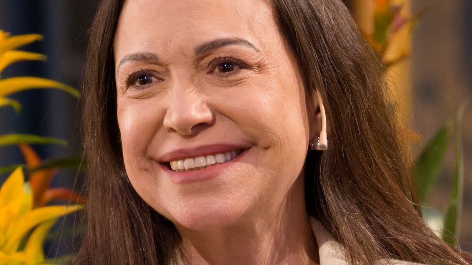 María Corina Machado smiling in a white blazer at a Nobel Peace Prize press conference in Oslo, in a December 2025 archive photo.