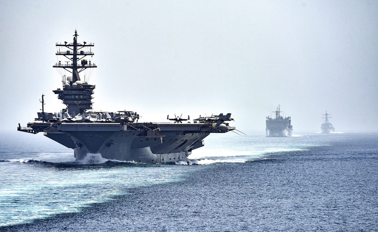 US Navy aircraft carrier and two ships transiting the Strait of Hormuz in 2016