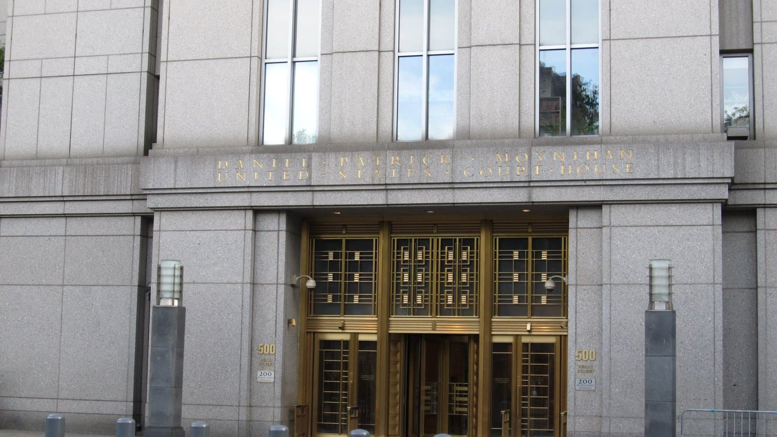 The entrance of the Daniel Patrick Moynihan U.S. Courthouse at 500 Pearl Street in Manhattan, with its name carved above brass doors, 2012.