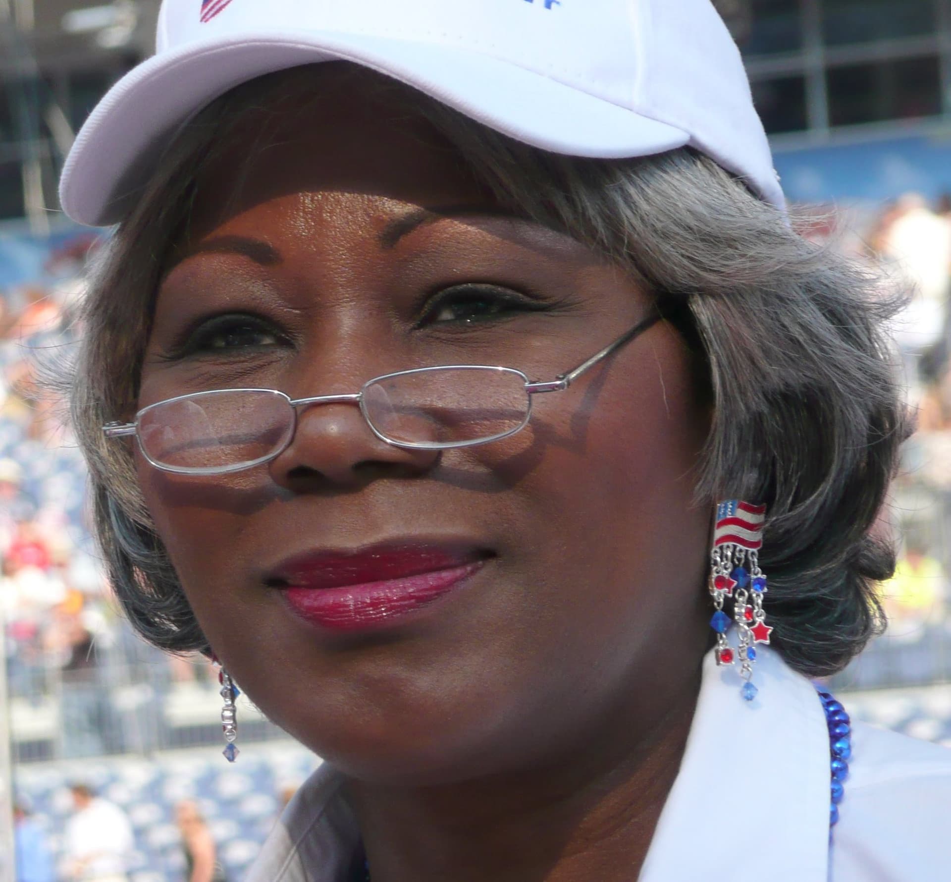 Archival portrait of Louise Lucas wearing glasses and a white cap at the 2008 Democratic convention