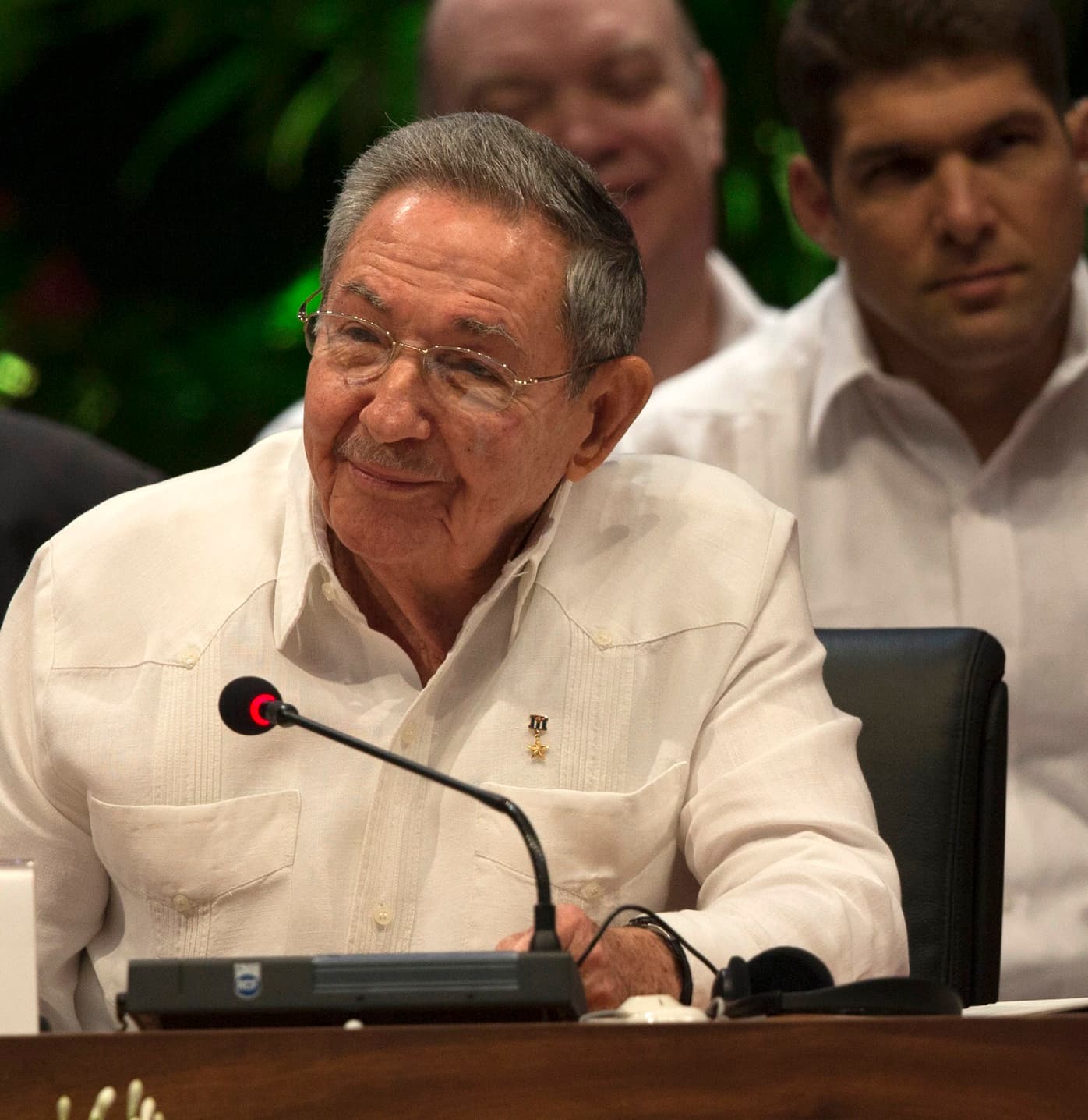 Raúl Castro seated at a microphone during a summit in June 2016.